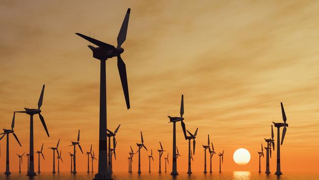 Offshore wind turbine farm at sunset.