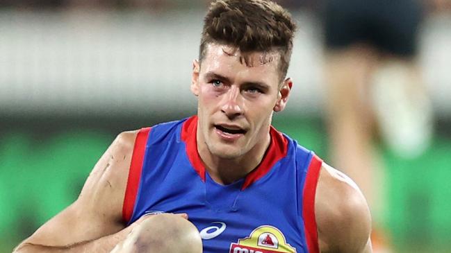 CANBERRA, AUSTRALIA - APRIL 23: Josh Dunkley of the Bulldogs injures his shoulder during the round six AFL match between the Greater Western Sydney Giants and the Western Bulldogs at Manuka Oval on April 23, 2021 in Canberra, Australia. (Photo by Cameron Spencer/Getty Images)