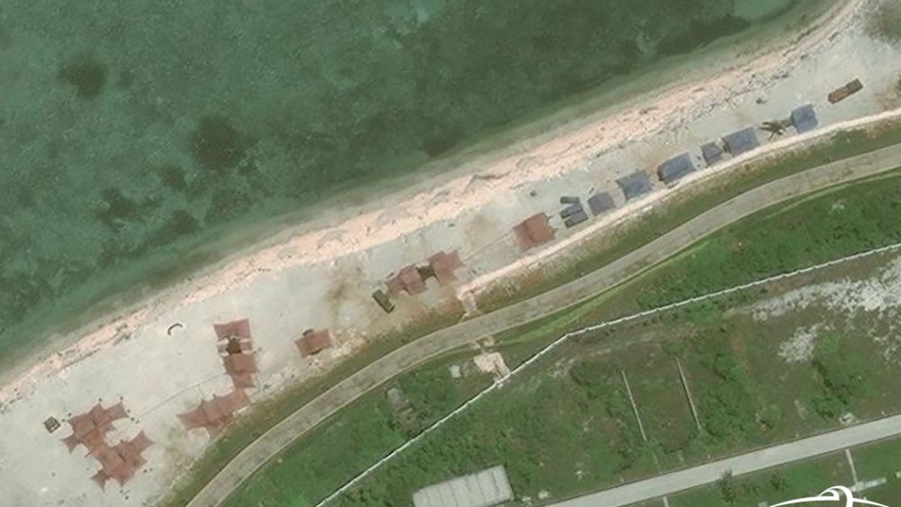 A satellite image showing several new emplacements covered by red and blue tarpaulins on one of Woody Island's beaches. It's believed these conceal new anti-air and anti-ship missile systems. Picture: CSIS/AMTI