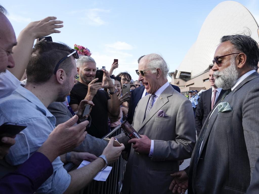 The bodyguard, on right, told royal fans outside the Opera House to put their phones down. Picture: Getty Images