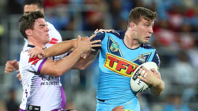 Jai Arrow of the Titans is tackled during the round 24 NRL match between the Gold Coast Titans and the Melbourne Storm. Photo: Getty Images