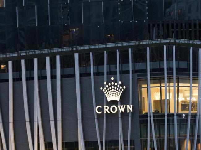 The Crown Resorts Ltd. logo is displayed at the Barangaroo South luxury hotel resort and One Barangaroo Crown residences development in Sydney, Australia, on Tuesday, Oct. 20, 2020. Crown Resorts' stock slumped the most since March on Oct. 19 after the casino operator said it’s being investigated for a potential breach of anti-money laundering and counter-terrorism financing rules. With Crown's annual meeting set for Oct. 22, the probe piles pressure on a company already beset by governance failures. Photographer: Brent Lewin/Bloomberg