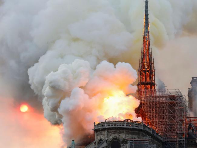 Smoke and flames rise during a fire at the landmark Notre-Dame Cathedral in central Paris on April 15, 2019, potentially involving renovation works being carried out at the site, the fire service said. (Photo by FRANCOIS GUILLOT / AFP)