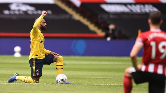 Arsenal's Alexandre Lacazette, left, and Sheffield United's Jack Robinson kneel in support of the Black Lives Matter movement before the English FA Cup quarter-final Picture: Getty