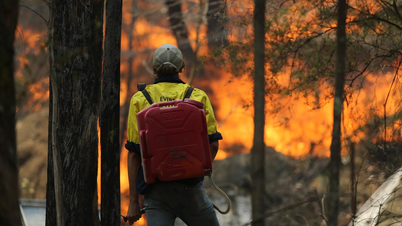 A man tires to save Secret Creek Animal Sanctuary in Cobar Park near Lithgow yesterday as bushfires continue to burn near the Blue Mountains. Picture: Tim Hunter