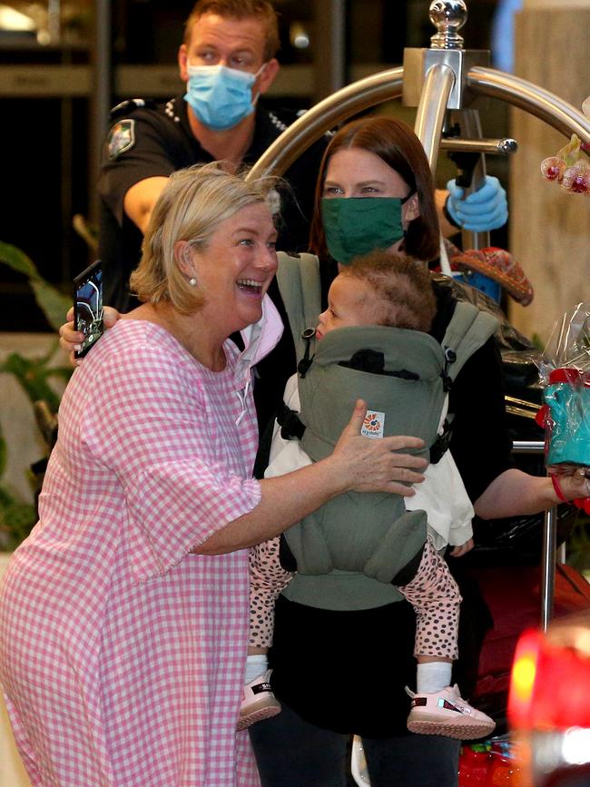 Ali Sherry greets her daughter Sarah Cowley and granddaughter Zara. Picture: David Clark