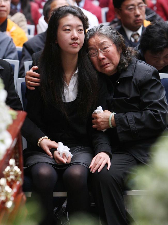 Brenda Lin with her grandmother Zhu Fenqin at the funeral service for her parents, brothers and aunt in 2009. Picture: Dean Marzolla