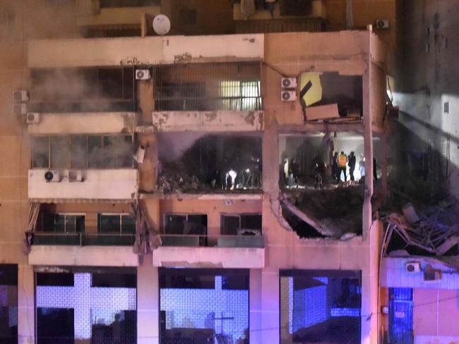 People inspect the site of a strike, reported by Lebanese media to be an Israeli strike targeting a Hamas office, in the southern suburb of Beirut. Picture: AFP