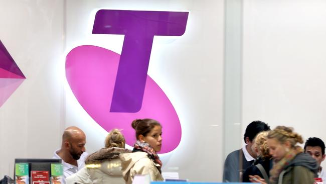 SYDNEY, AUSTRALIA - JULY 24: Shoppers in a Telstra retail store in Sydney's CBD browse products on July 24, 2014 in Sydney, Australia. Telstra's Global Services Devision will be moving 463 existing Telstra roles and 208 contractor jobs to India. Telstra staff were officially informed of the decision yesterday afternoon. (Photo by James Alcock/Getty Images)