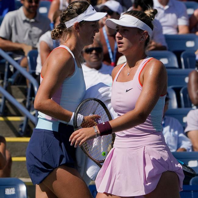 Belarus' Victoria Azarenka (L) and against Ukraine's Marta Kostyuk cross during the match. Timothy A. Clary / AFP