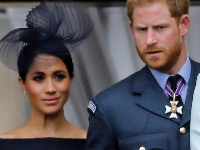 (FILES) In this file photo taken on July 10, 2018 (L-R) Britain's Camilla, Duchess of Cornwall, Britain's Queen Elizabeth II, Britain's Meghan, Duchess of Sussex, Britain's Prince Harry, Duke of Sussex, and Britain's Prince William, Duke of Cambridge come onto the balcony of Buckingham Palace to watch a military fly-past to mark the centenary of the Royal Air Force (RAF). - Britain's Prince Harry and his wife Meghan will give up their titles and stop receiving public funds following their decision to give up front-line royal duties, Buckingham Palace said on January 18, 2020. "The Sussexes will not use their HRH titles as they are no longer working members of the Royal Family," the Palace said, adding that the couple have agreed to repay some past expenses. (Photo by Tolga AKMEN / AFP)