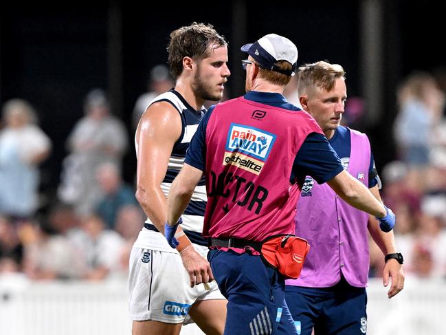 Jake Kolodjashnij is helped from the field after knocking his head. Picture: Bradley Kanaris/Getty Images