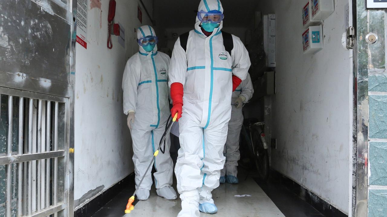 Staff disinfecting a residential area in China’s central Jiangxi province, which neighbours Hubei province. Picture: STR/AFP