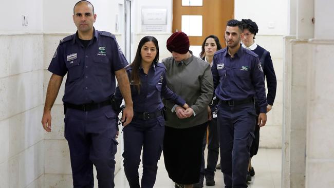 Malka Leifer (centre) is escorted by police as she arrives for a hearing at the District Court in Jerusalem. Picture: AFP