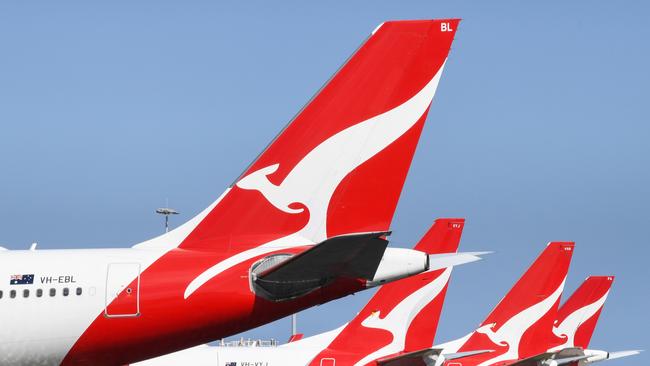 SYDNEY, AUSTRALIA - AUGUST 18: The tail fins of Qantas aircraft parked at Sydney's Kingsford Smith International Airport on August 18, 2021 in Sydney, Australia. Qantas Group has announced COVID-19 vaccinations will be mandatory for all 22,000 staff members. Frontline employees Ã¢â¬â including cabin crew, pilots and airport workers Ã¢â¬â will need to be fully vaccinated by November 15 and the remainder of employees by March 31. There will be exemptions for those who are unable to be vaccinated for documented medical reasons, which is expected to be very rare. (Photo by James D. Morgan/Getty Images)