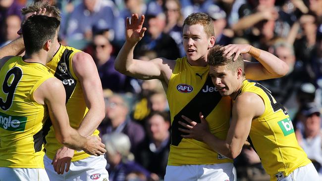 Jacob Townsend celebrates a goal against Fremantle with Trent Cotchin and Dan Butler.