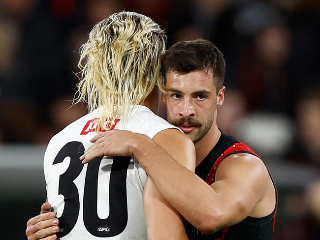MELBOURNE, AUSTRALIA - APRIL 25: Darcy Moore of the Magpies and Kyle Langford of the Bombers embrace after a draw during the 2024 AFL Round 07 match between the Essendon Bombers and the Collingwood Magpies at the Melbourne Cricket Ground on April 25, 2024 in Melbourne, Australia. (Photo by Michael Willson/AFL Photos via Getty Images)
