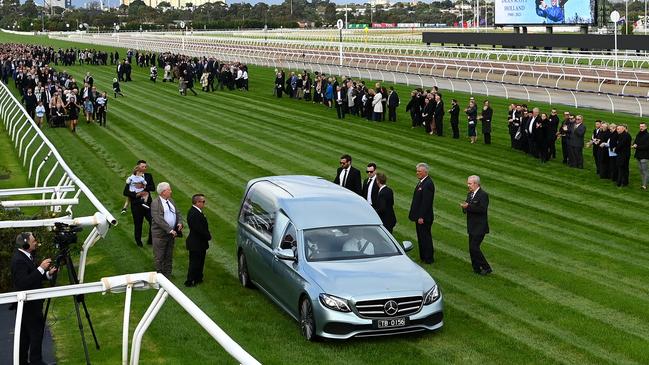 A guard of honour is formed as the hearse goes down the Flemington straight during a funeral service for jockey Dean Holland. Picture: Quinn Rooney/Getty Images.