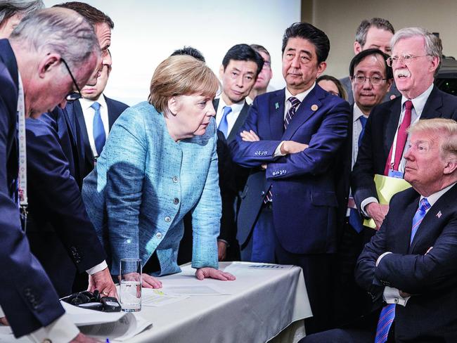 TWAM20190126 EMBARGO FOR TWAM 26 JAN 2019 NO REUSE WITHOUT PERMISSIONFEE MAY APPLYCHARLEVOIX, CANADA - JUNE 9:   In this photo provided by the German Government Press Office (BPA), German Chancellor Angela Merkel deliberates with US president Donald Trump on the sidelines of the official agenda on the second day of the G7 summit on June 9, 2018 in Charlevoix, Canada. Also pictured are (L-R) Larry Kudlow, director of the US National Economic Council, Theresa May, UK prime minister, Emmanuel Macron, French president, Angela Merkel, Yasutoshi Nishimura, Japanese deputy chief cabinet secretary, Shinzo Abe, Japan prime minister, Kazuyuki Yamazaki, Japanese senior deputy minister for foreign affairs, John Bolton, US national security adviser, and Donald Trump. Canada are hosting the leaders of the UK, Italy, the US, France, Germany and Japan for the two day summit.(Photo by Jesco Denzel /Bundesregierung via Getty Images)