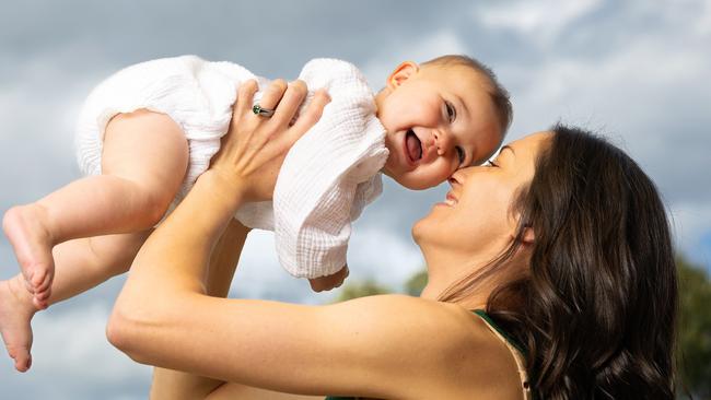 MELBOURNE, OCTOBER 24, 2024: Lara Scott, pictured with daughter Elsie, 8 months. Cancer survivor Lara Scott was diagnosed with a rare type of thyroid cancer shortly after her first-baby Ada was born and fought it twice.When she was pregnant with her second daughter, Elsie, in February this year, she felt unwell and went to the emergency department - where she then had a heart attack. She was eventually diagnosed with an extremely rare - and unrelated to her first - type of cancer which impacted her adrenaline levels - causing the heart attack. She would not have bothered to seek help that night if she hadn't been pregnant - she was worried for her baby and feared it was pre-eclampsia. Her baby Elsie saved her life. Picture: Mark Stewart