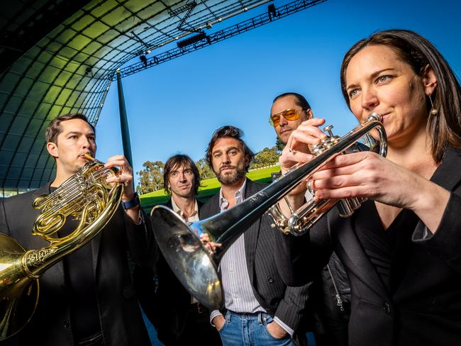 Members of rock band JET, Cameron Muncey, Nic Cester and Mark Wilson are joined by MSO musicians Nico Fleury and Rosie Turner to promote their show at Myer Music Bowl in November. Picture: Jake Nowakowski