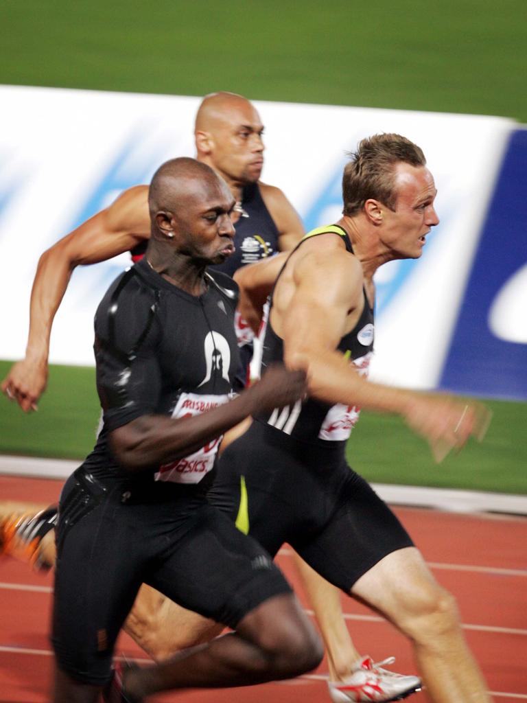 Otis Gowa (left) pushes away from sprinters Matt Shirvington and Patrick Johnson to win the men's national 100m final.