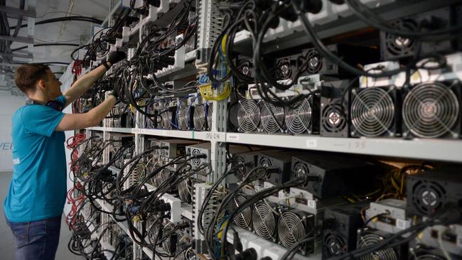 An employee inspects computers mining bitcoins and lightcoins at the "CryptoJuniversóe" mining centre in Kirishi, Russia, in 2018. Picture: AFP