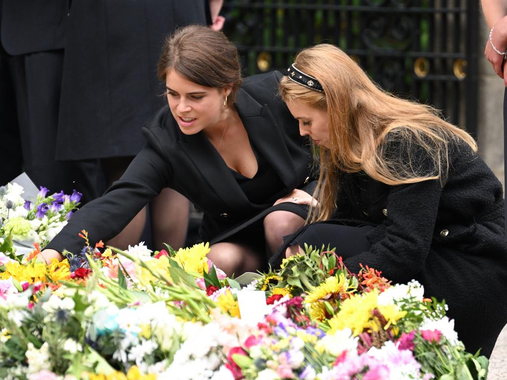 Princess Eugenie and Princess Beatrice view the flowers left by mourners outside Balmoral Castle. Photo: WireImage