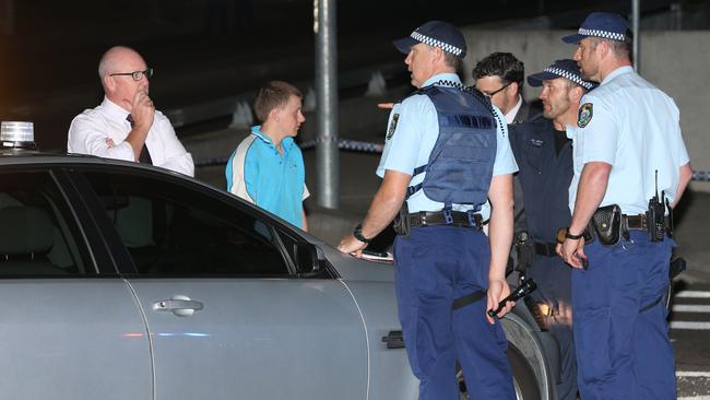 Police talk to a youth at the scene of a stabbing near Rouse Hill shopping centre. Picture by DAMIAN SHAW