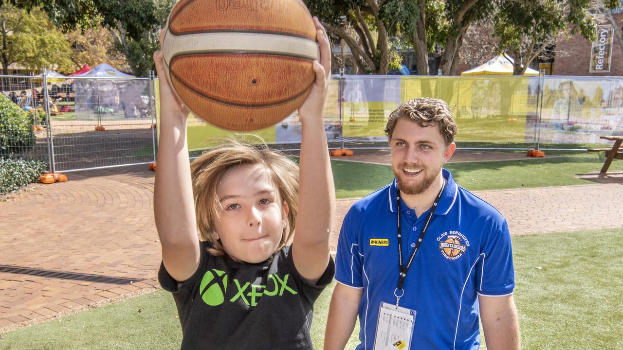 Lawson Bowa receives some basketball tips from Mountaineers coach Matt Cox at the USQ open day. Sunday, August 15, 2021. Picture: Nev Madsen.