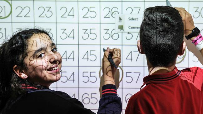 St Leo's primary school in Altona North has posted growth in NAPLAN scores across multiple learning areas in recent years. Grade 5 students Mia and Ryan are at work on the whiteboard in the classroom. Picture: Ian Currie