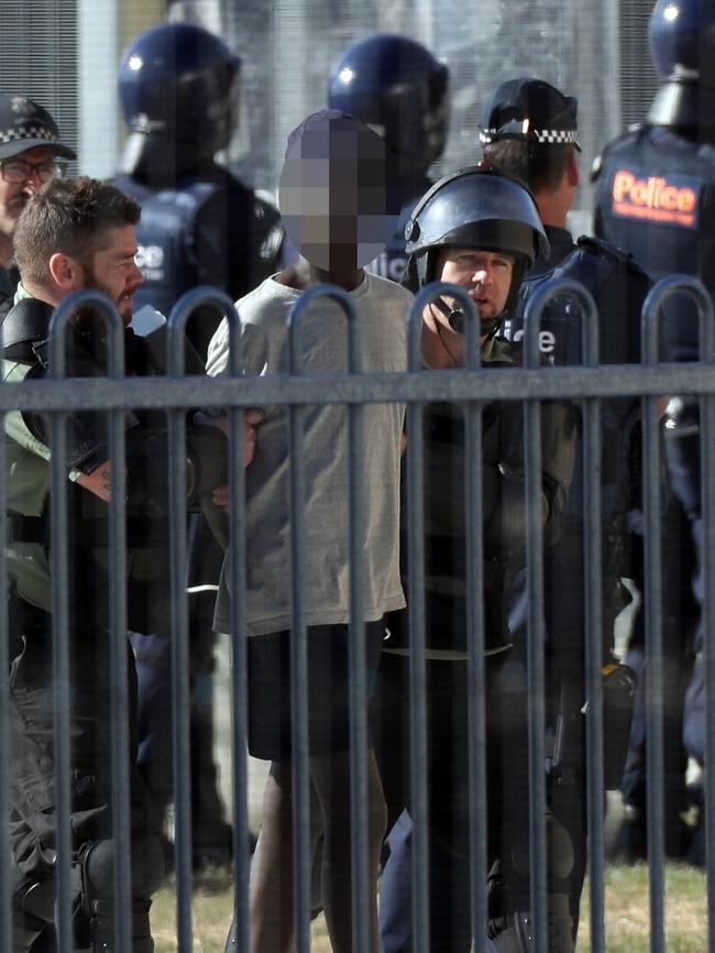 One of the inmates being taken into custody. Picture: Aaron Francis