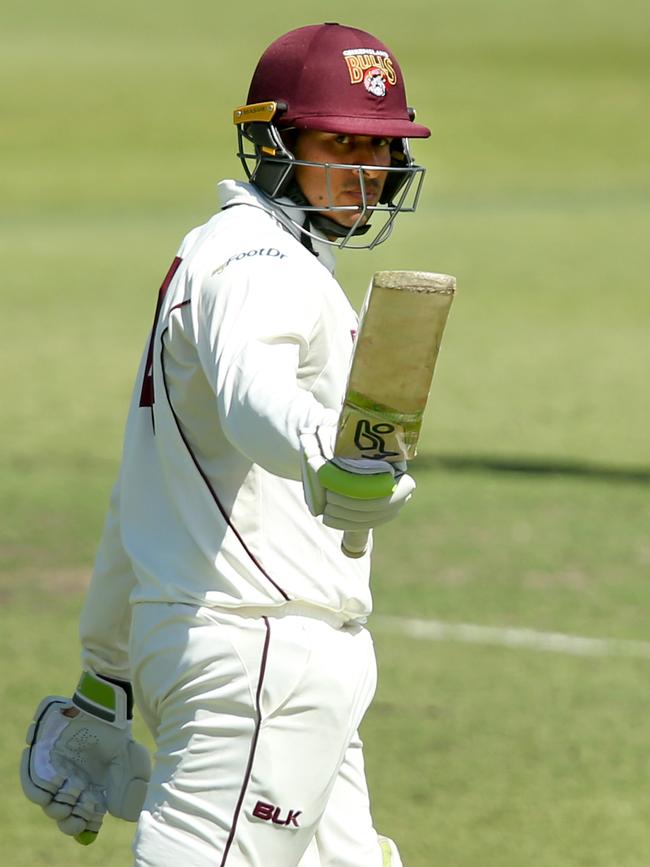 Usman Khawaja of Queensland raises his bat after making a half-century. (AAP Image/Jono Searle)