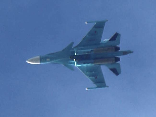 (FILES) In this file photo taken on February 20, 2018 shows a Russian air force Sukhoi Su-34 fighter jet flying over the sky in the rebel-held town of Arbin, in the besieged Eastern Ghouta region on the outskirts of the capital Damascus. - A Russian military plane crashed on October 17, 2022, into a residential area in Yeysk, a town in southwestern Russia near the border with Ukraine, Russian news agencies reported, quoting the defence ministry. 