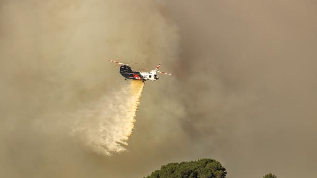 A fire burns through farmland near Flowerdale, CFA and firefighting aircraft including the chinook drop water on it. Picture: Jason Edwards