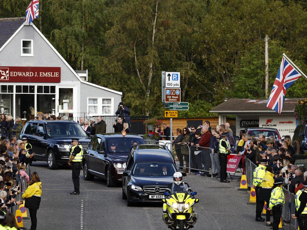 People gather in tribute as the cortege carrying the coffin of the late Queen Elizabeth II passes by in Ballater. Picture: Getty Images.