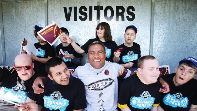 Petero Civoniceva poses with members of Kuraby Hub at Multicap’s Inter-Service Rugby League Cup at Dolphin's Leagues Club in Redcliffe. Photo: AAP /Claudia Baxter