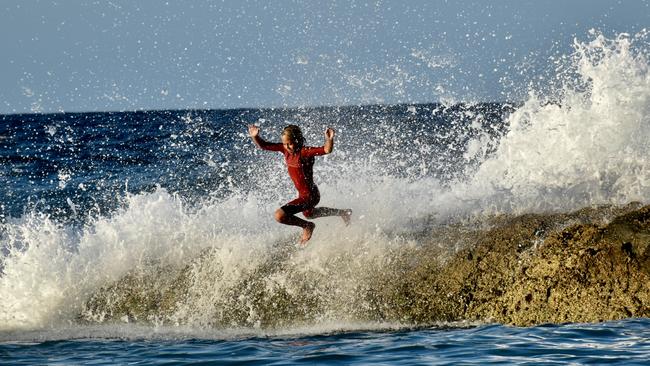 Young swimmers knocked down by swell at Snapper Rocks on the Gold Coast generated by Tropical Cyclone Oma. Picture: Mark Furler