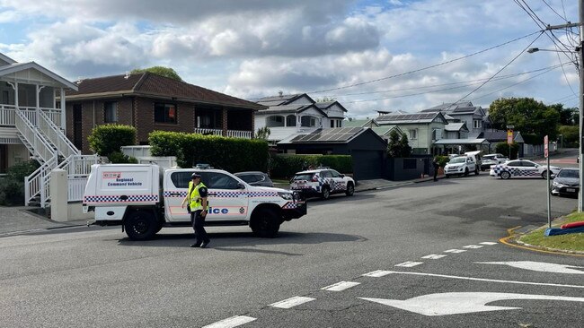 Police crews close a street at Grange in Brisbane where a man was found with a stab wound as emergency crews responded to a fire at a home. Picture: Andreas Nicola