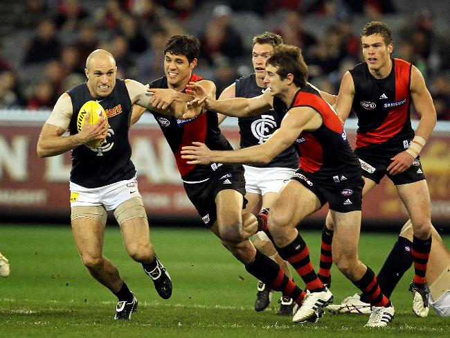 <p>Chris Judd breaks away against Essendon.</p>