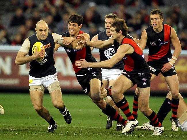 Chris Judd breaks away against Essendon.