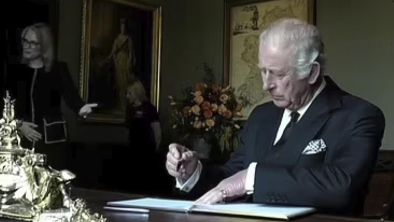 King Charles gets frustrated at a fountain pen leaking on his fingers while signing the guest book at Hillsborough Castle, Northern Ireland. Supplied