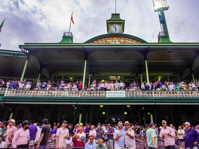 Cricket fans enjoy the action from the members pavilion on the first day of the Sydney Test, David Warner's last test match. Photographer: Tom Parrish