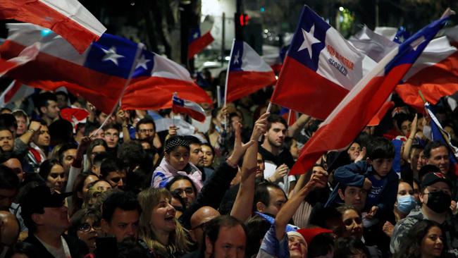 Opponents of the new constitution celebrate in Santiago on Sunday. Picture: AFP