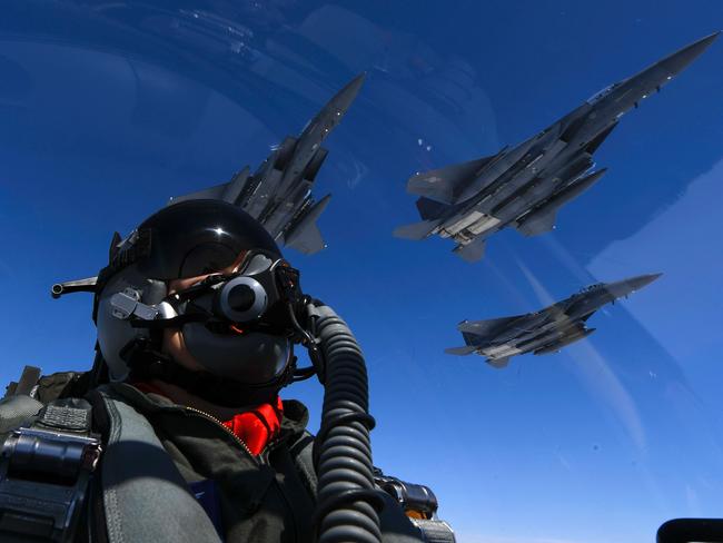 A US Air Force pilot join up with Republic of Korea air force F-15s during a 10-hour mission from Andersen Air Force Base, Guam, into Japanese airspace and over the Korean Peninsula on July 30. Picture: US Air Force/AFP