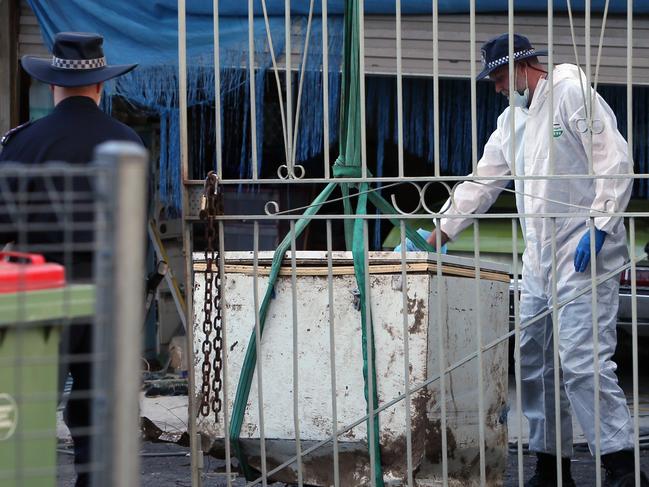 Police remove a chest freezer from a crime scene at Parker St Goodna. Monday 1st April 2019. (AAP Image/Richard Waugh)