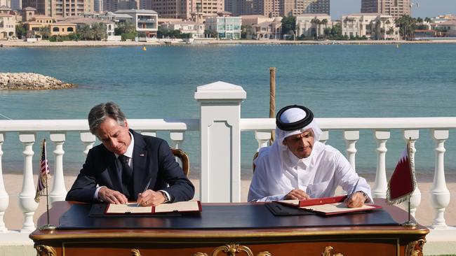 US Secretary of State Antony Blinken, left, and Qatar's Foreign Minister Mohammed Bin Abdulrahman Al Thani sign documents following a meeting in Doha. Picture: AFP