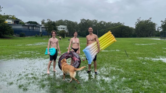 The Kailas family (safely) had some fun on the Indooroopilly State High School playing fields on Saturday. It looks way worse now Sandy Creek has broken its banks.