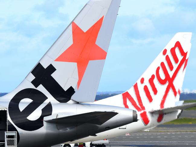 SYDNEY, AUSTRALIA - NCA NewsWire Photos JULY, 28, 2020: A Jetstar and Virgin Australian Aircraft are seen on the tarmac at Sydney Airport. An infectious woman who flew from Melbourne to Sydney, on Jetstar flight JQ506 on July 25th, has tested positive to COVID-19 (Coronavirus). Picture: NCA NewsWire / Bianca De Marchi