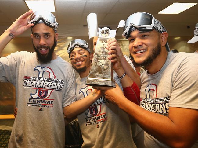 HOUSTON, TX - OCTOBER 18: (L-R) David Price #24, Mookie Betts #50, and Eduardo Rodriguez #57 of the Boston Red Sox celebrate with the William Harridge Trophy in the clubhouse after defeating the Houston Astros 4-1 in Game Five of the American League Championship Series to advance to the 2018 World Series at Minute Maid Park on October 18, 2018 in Houston, Texas.   Elsa/Getty Images/AFP == FOR NEWSPAPERS, INTERNET, TELCOS & TELEVISION USE ONLY ==